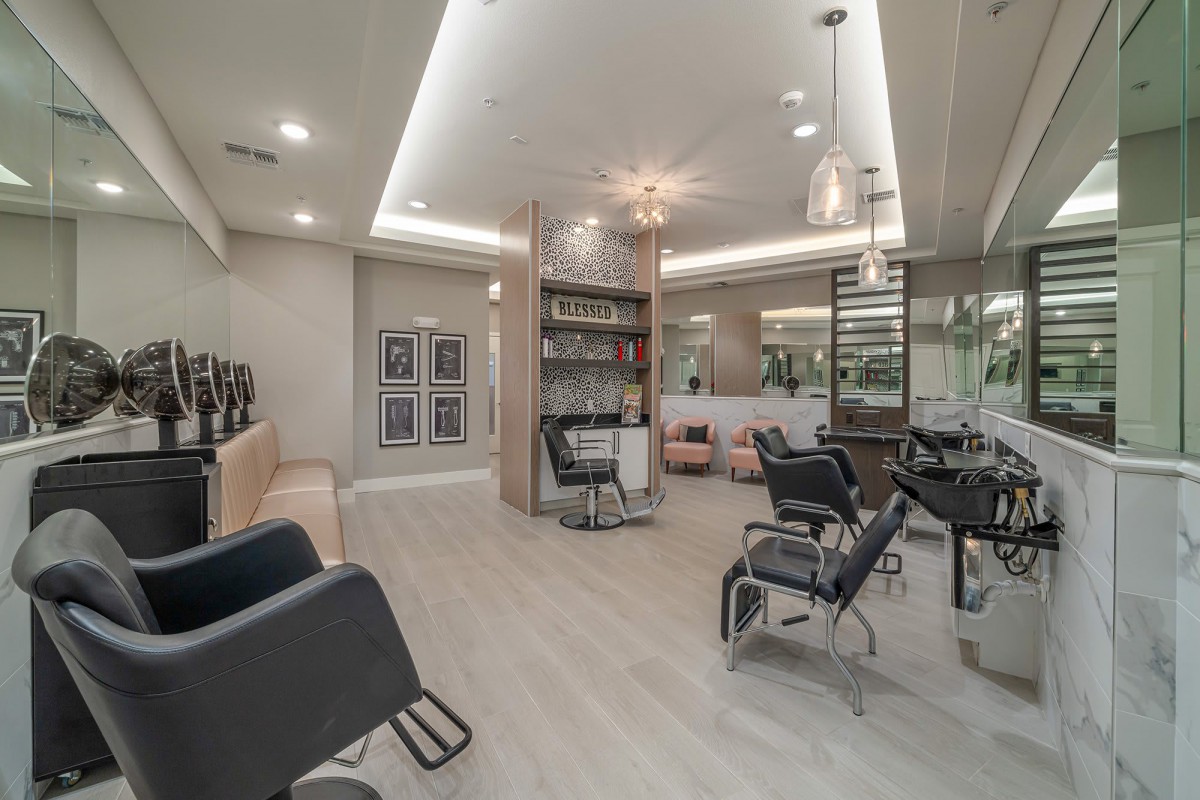 Modern salon interior with styling stations and chairs.