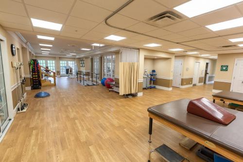 A spacious and well-equipped physical therapy room designed for rehabilitation and wellness activities.