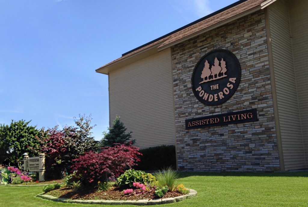A well-maintained assisted living facility with attractive landscaping and clear signage.