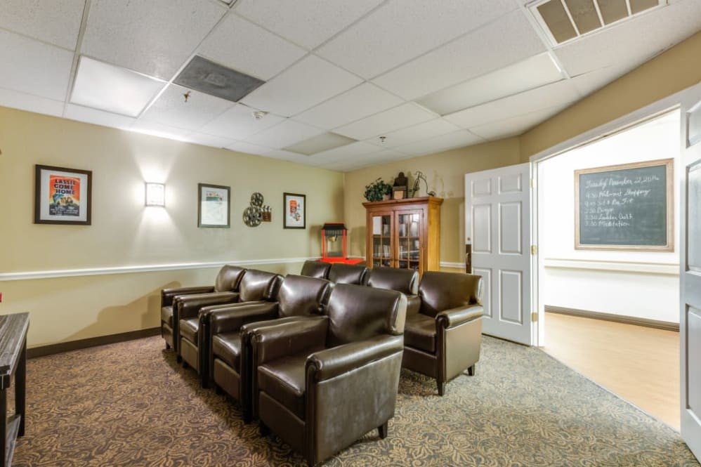 A cozy waiting room with leather chairs and warm lighting.