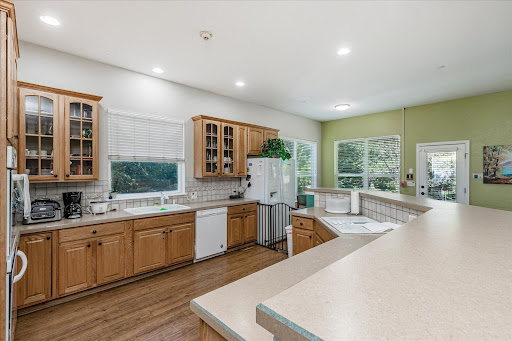 A spacious and inviting kitchen featuring wooden cabinets and ample natural light.
