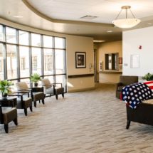 A spacious and well-lit lobby area with comfortable seating and large windows.