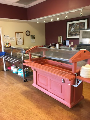 A cozy caf setting featuring a buffet service area with food displays.