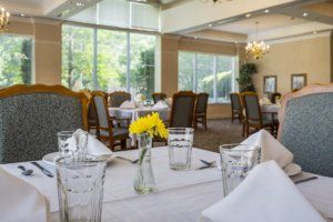 Elegant dining area with natural lighting and well-arranged tables.