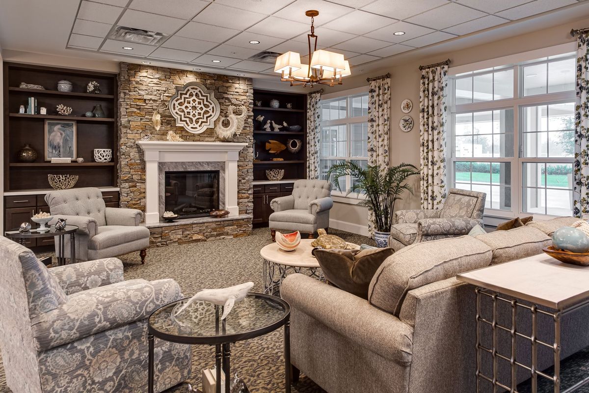 A cozy living room with elegant furnishings and a fireplace.