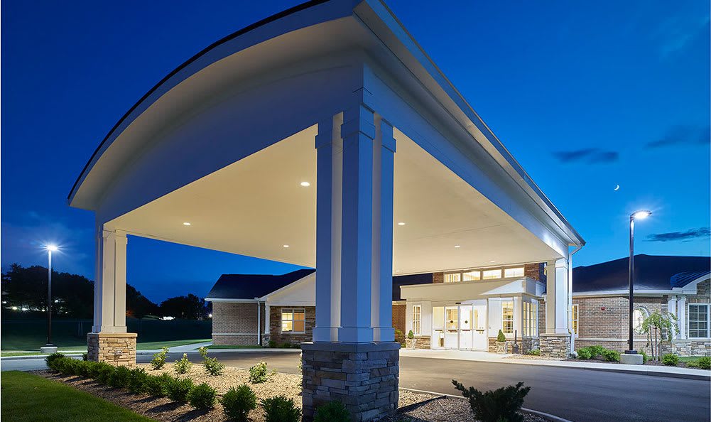 A modern building entrance illuminated at night.