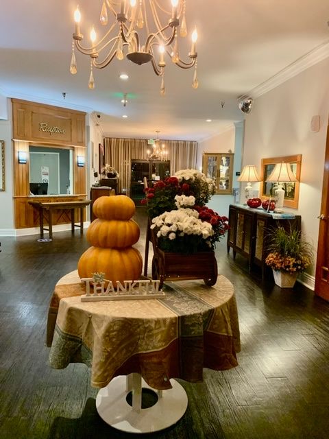A cozy interior adorned with pumpkins and flowers, creating a warm autumn atmosphere.
