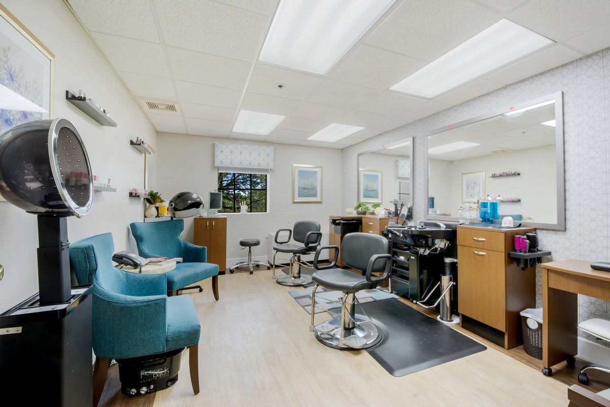 A modern hair salon with styling chairs, mirrors, and salon equipment.