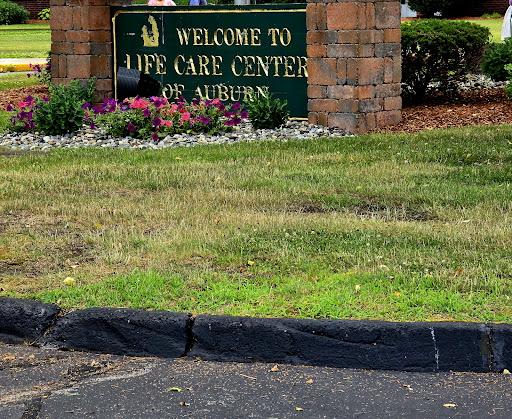 Welcome sign at the Life Care Center in Auburn, surrounded by landscaping.