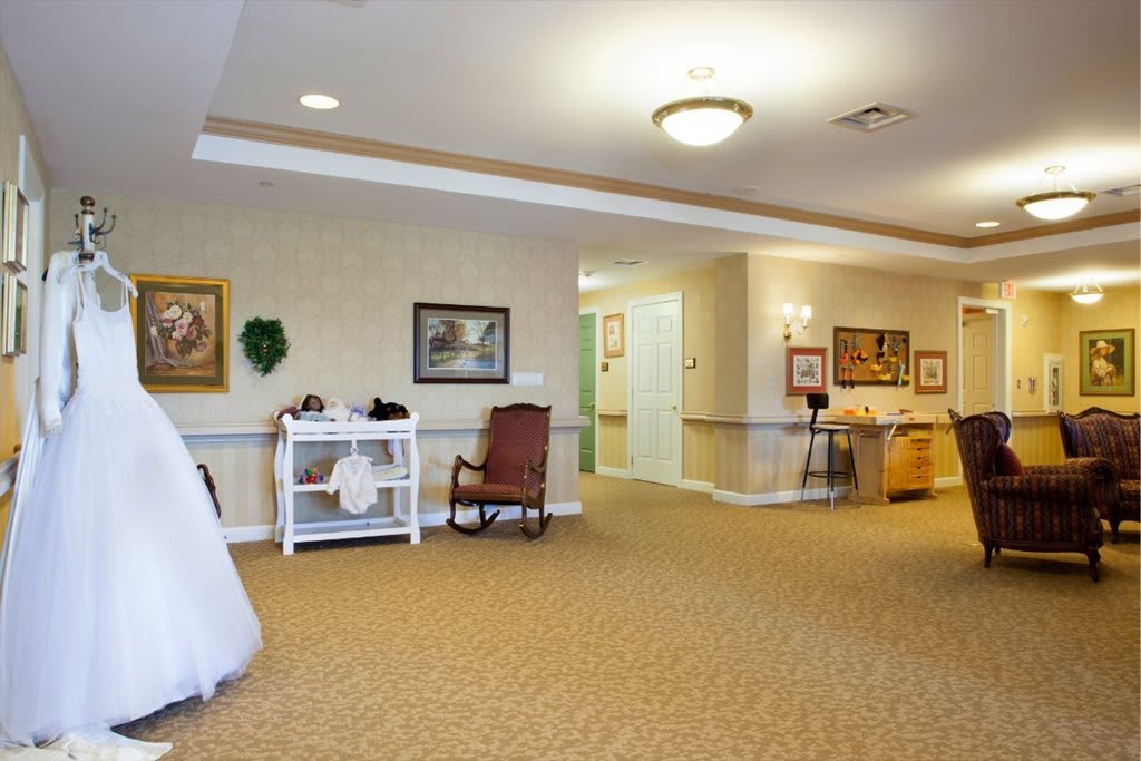 A spacious, well-lit hallway with decorative furniture and art on the walls.