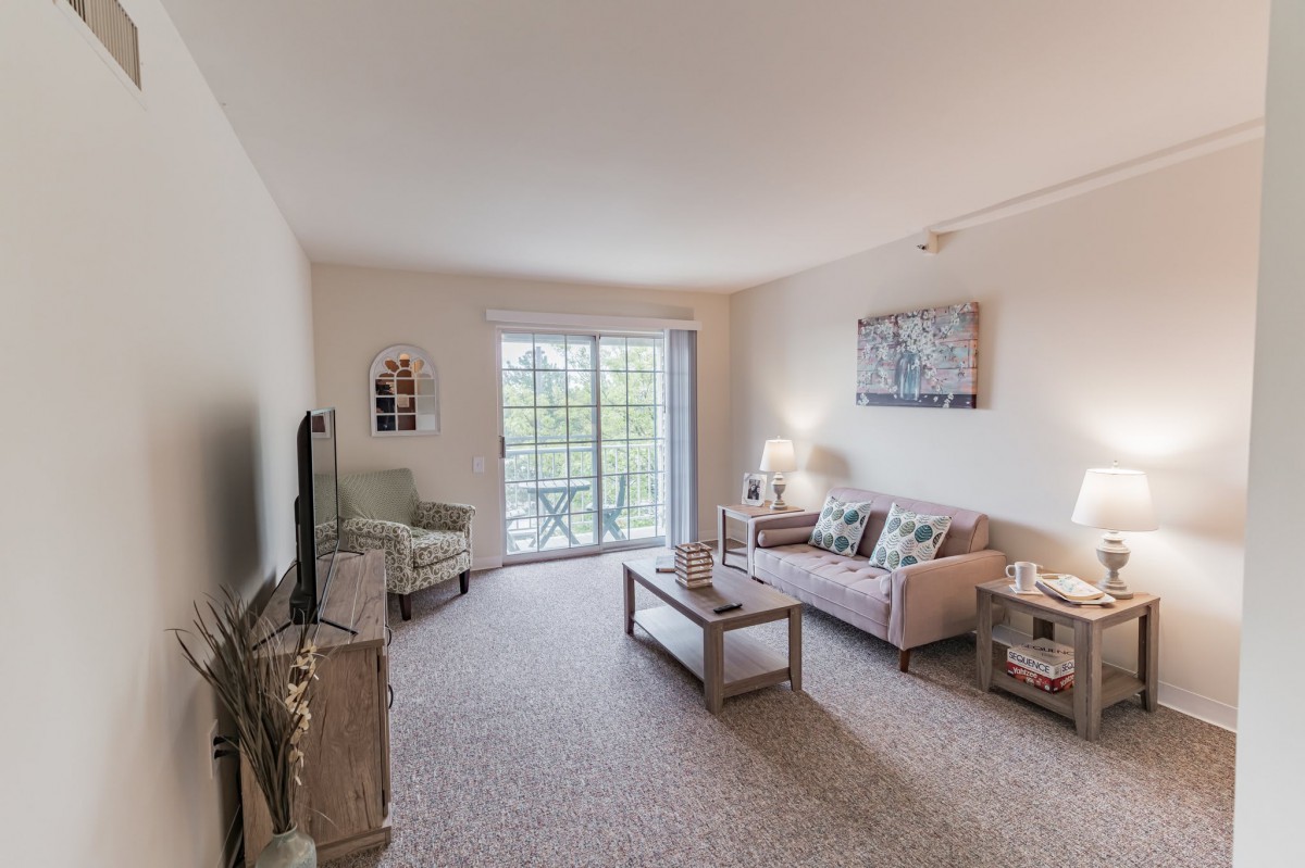 A modern living room with comfortable seating and abundant natural light.