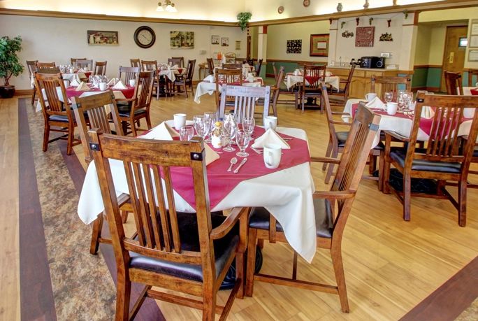 A cozy restaurant dining area with neatly set tables and wooden chairs.