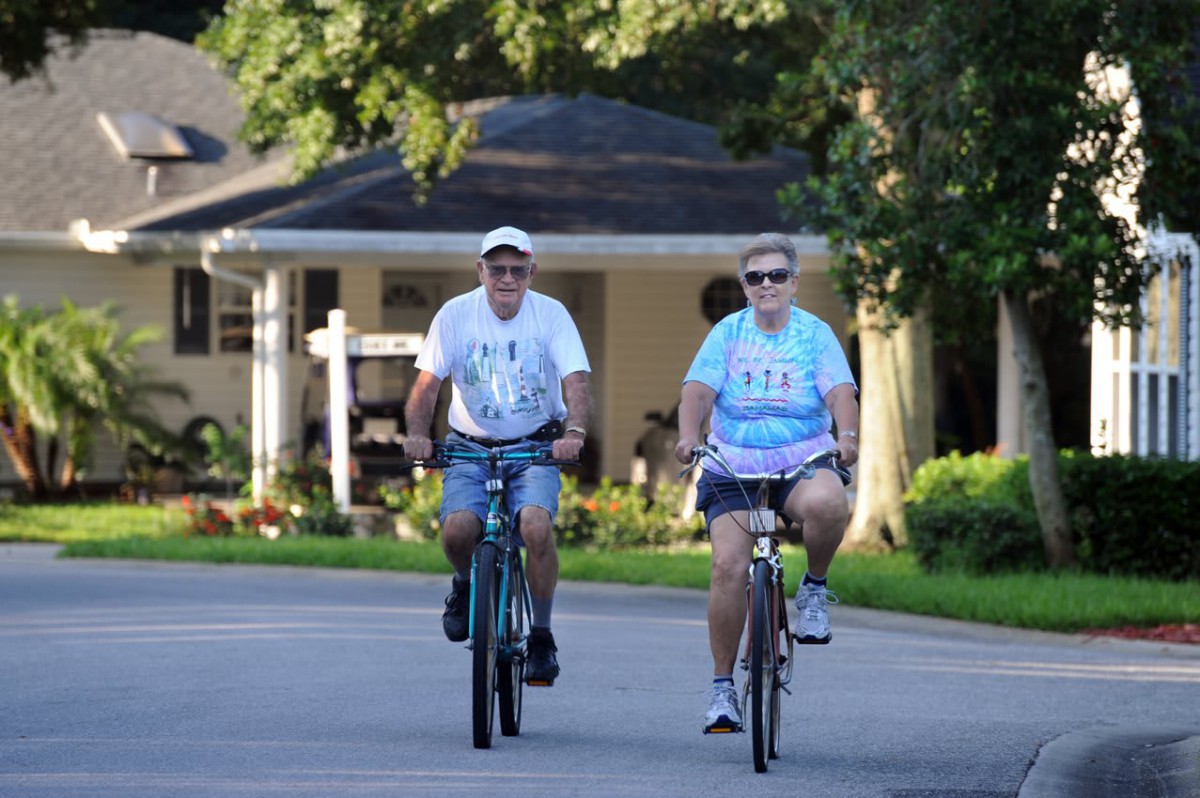 Two people enjoying a leisurely bicycle ride on a sunny day.