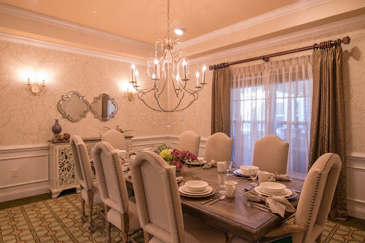 An elegant dining room featuring a beautifully set table and a stunning chandelier.
