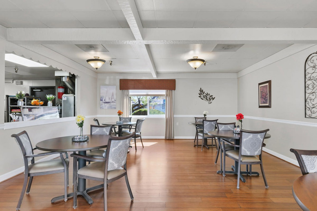 A well-lit dining area with modern decor and wooden flooring.