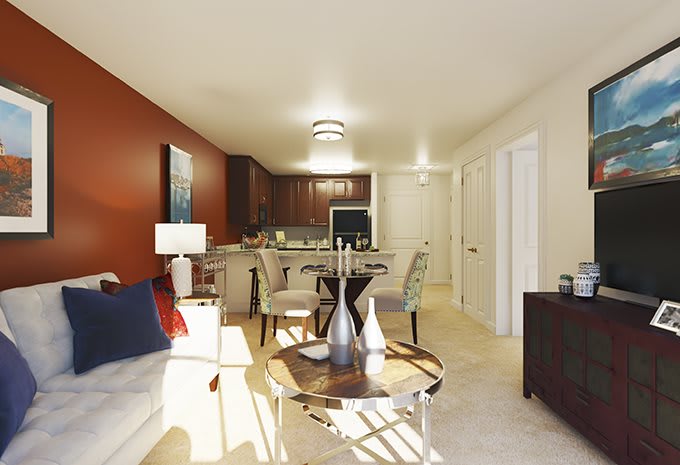 A modern apartment showcasing an open floor plan with a cozy living room, dining area, and kitchen.