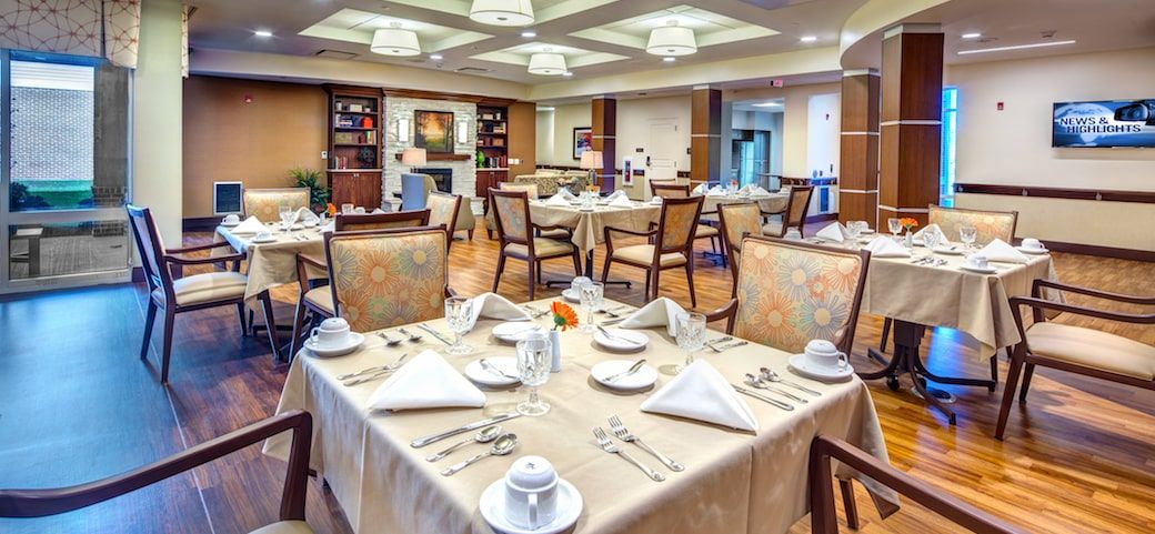 Elegantly set tables in a well-decorated dining room.