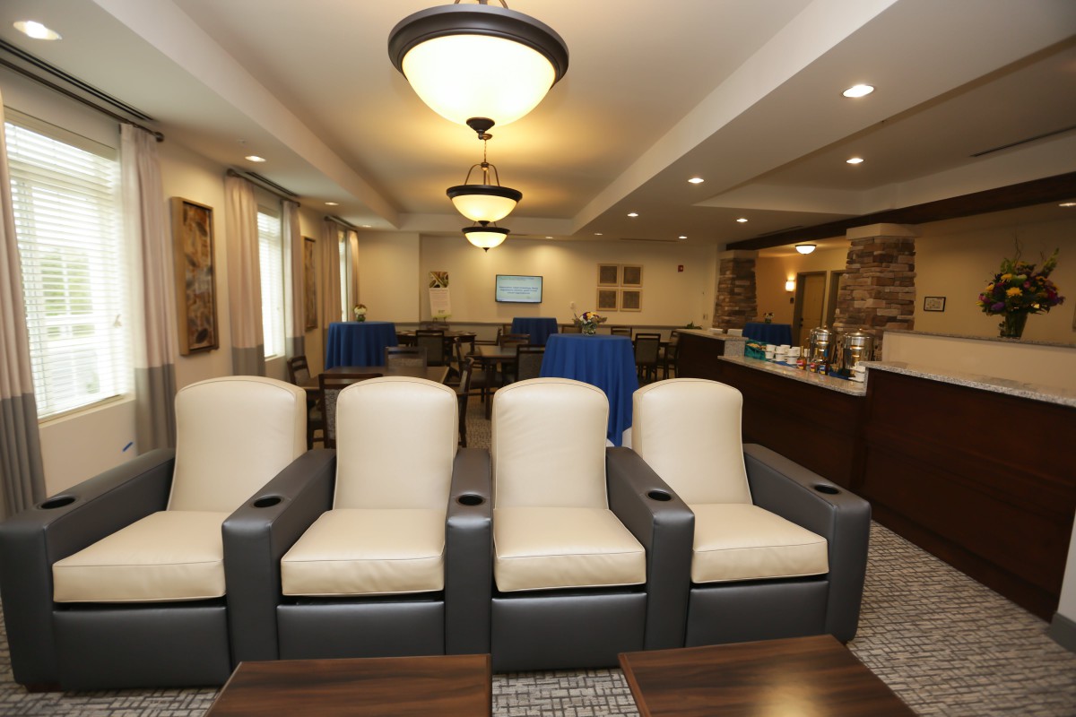 A modern lounge area with comfortable seating and elegant lighting.