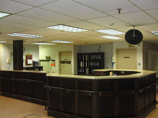 A view of a reception area featuring a dark counter and office environment.