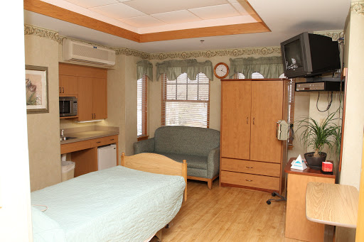 A comfortable hospital room featuring essential furniture for patients.