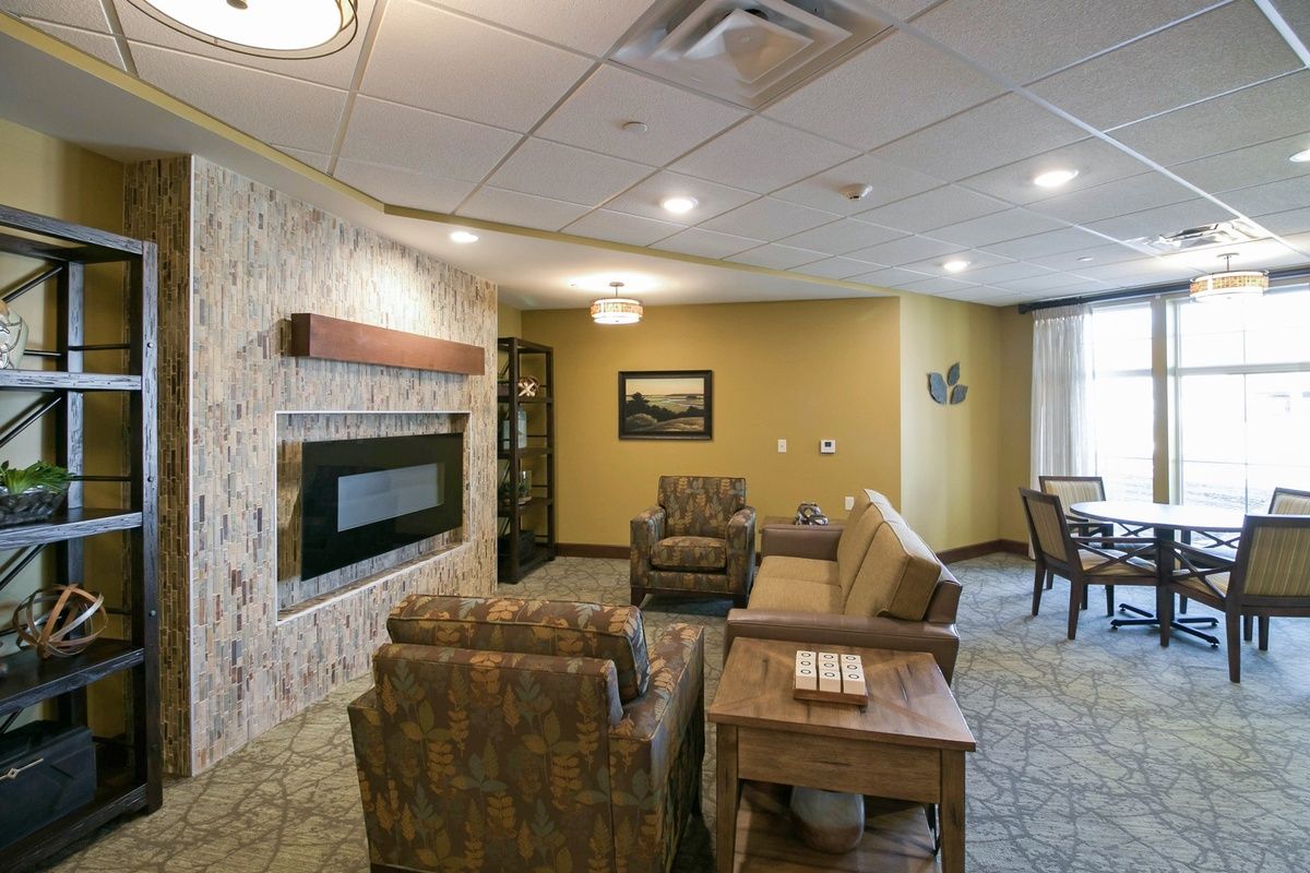 A cozy living room with comfortable seating and a modern fireplace.