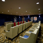 A cozy home theater with comfortable seating and a carpeted floor.