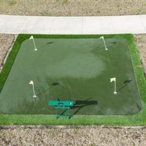 An outdoor putting green with four flags for golf practice.