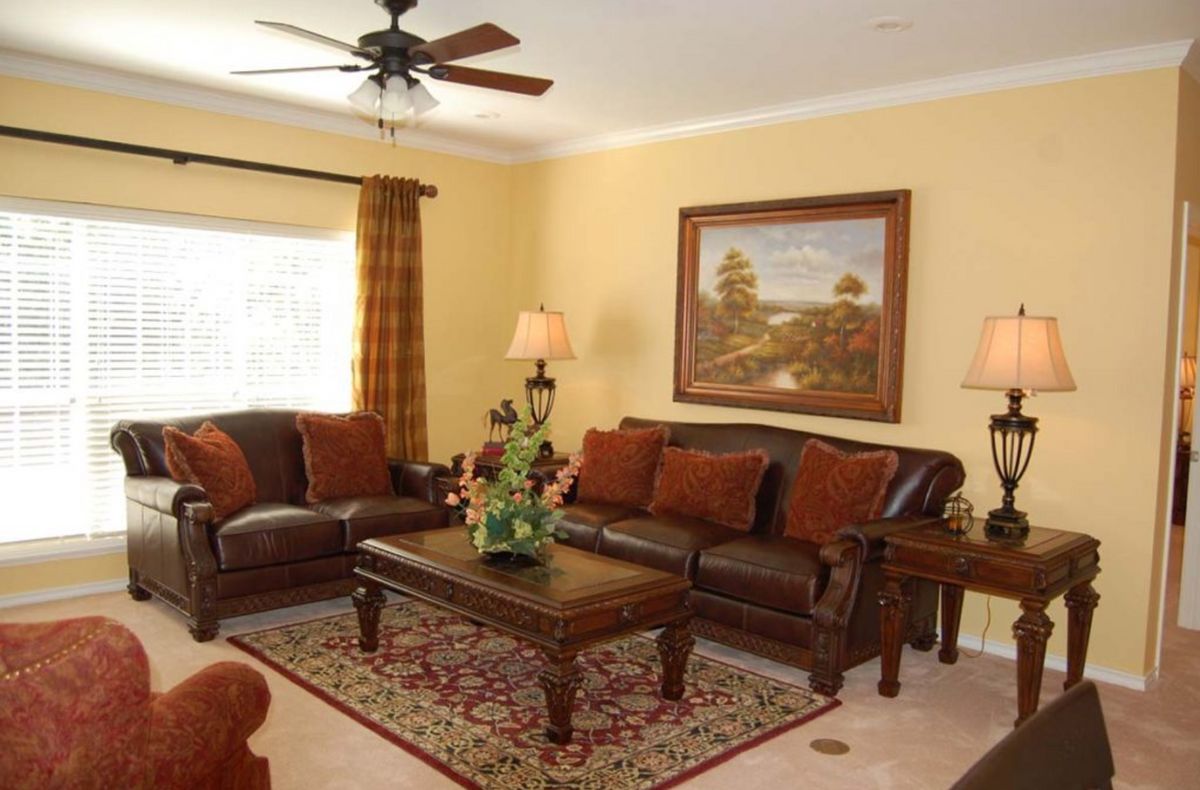 A cozy living room with a sofa set, decorative lamps, and a central coffee table.