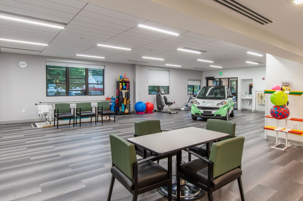 A spacious therapy center with modern equipment and seating areas.