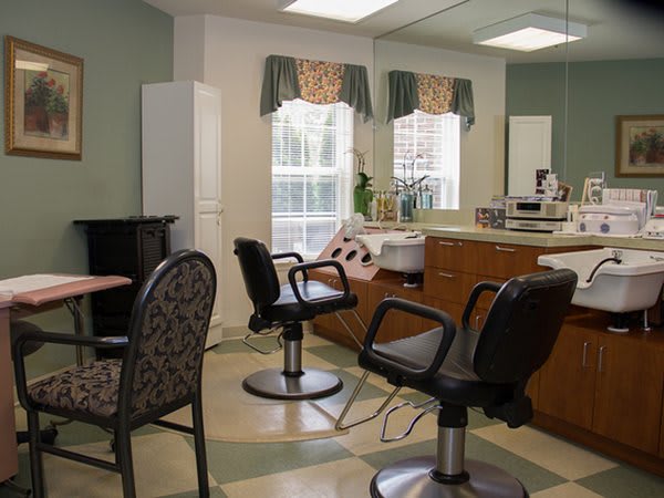A cozy hair salon with styling chairs and mirrors.