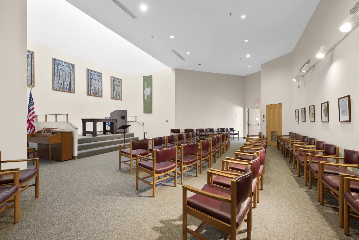 A modern chapel interior with arranged seating and minimalist design.