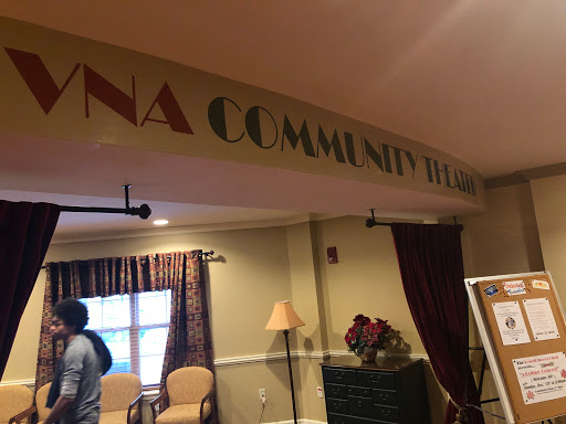 A welcoming community center space featuring a decorative sign.