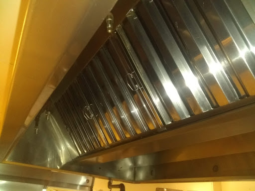 A shiny stainless steel kitchen hood, designed for ventilation while cooking.