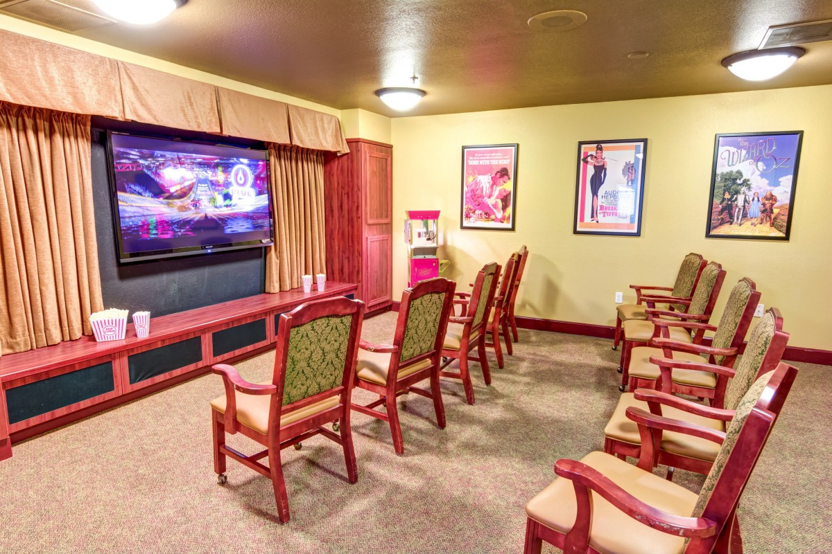 A cozy home theater with arranged seating and a large screen.