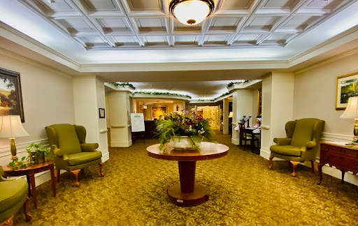 A spacious and inviting lobby featuring comfortable seating and a decorative table with plants.