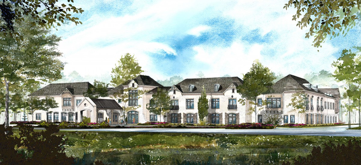 A picturesque view of a large residential building surrounded by trees and greenery under a clear blue sky.