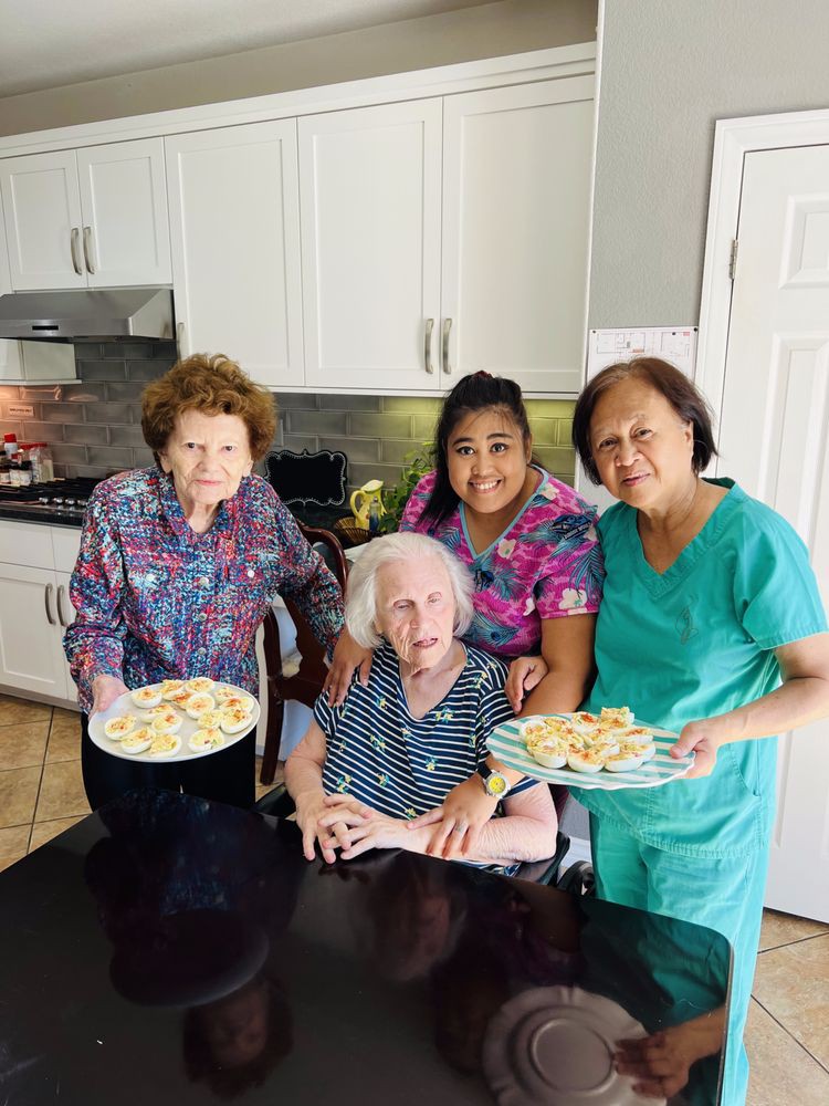 A group of people enjoying time together in the kitchen, displaying freshly baked cookies.