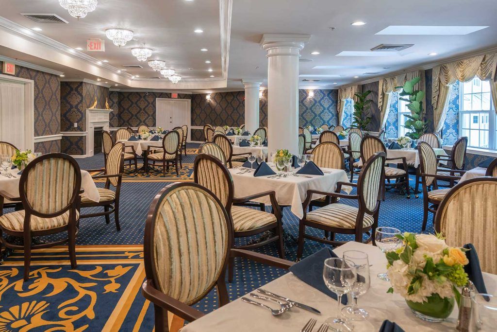 An elegant dining room with beautifully set tables and classic decor.