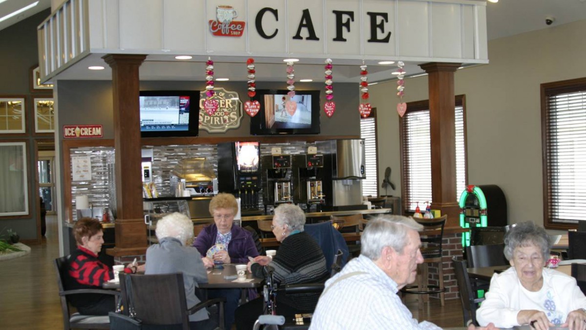 Seniors enjoying a gathering at a cozy cafe.