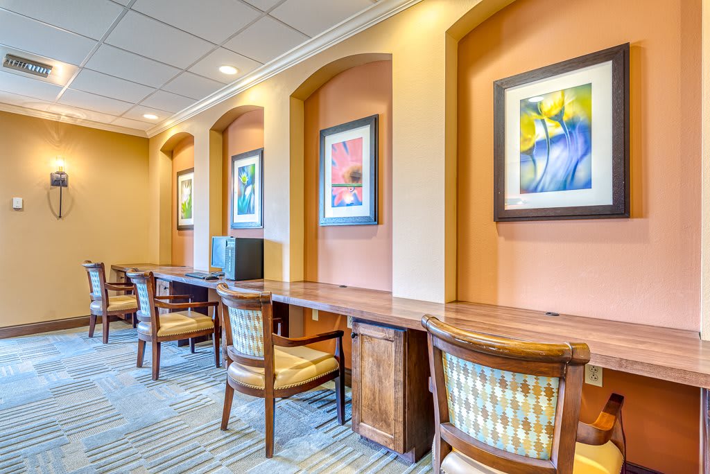 A well-lit office space with multiple workstations and colorful artwork on the walls.