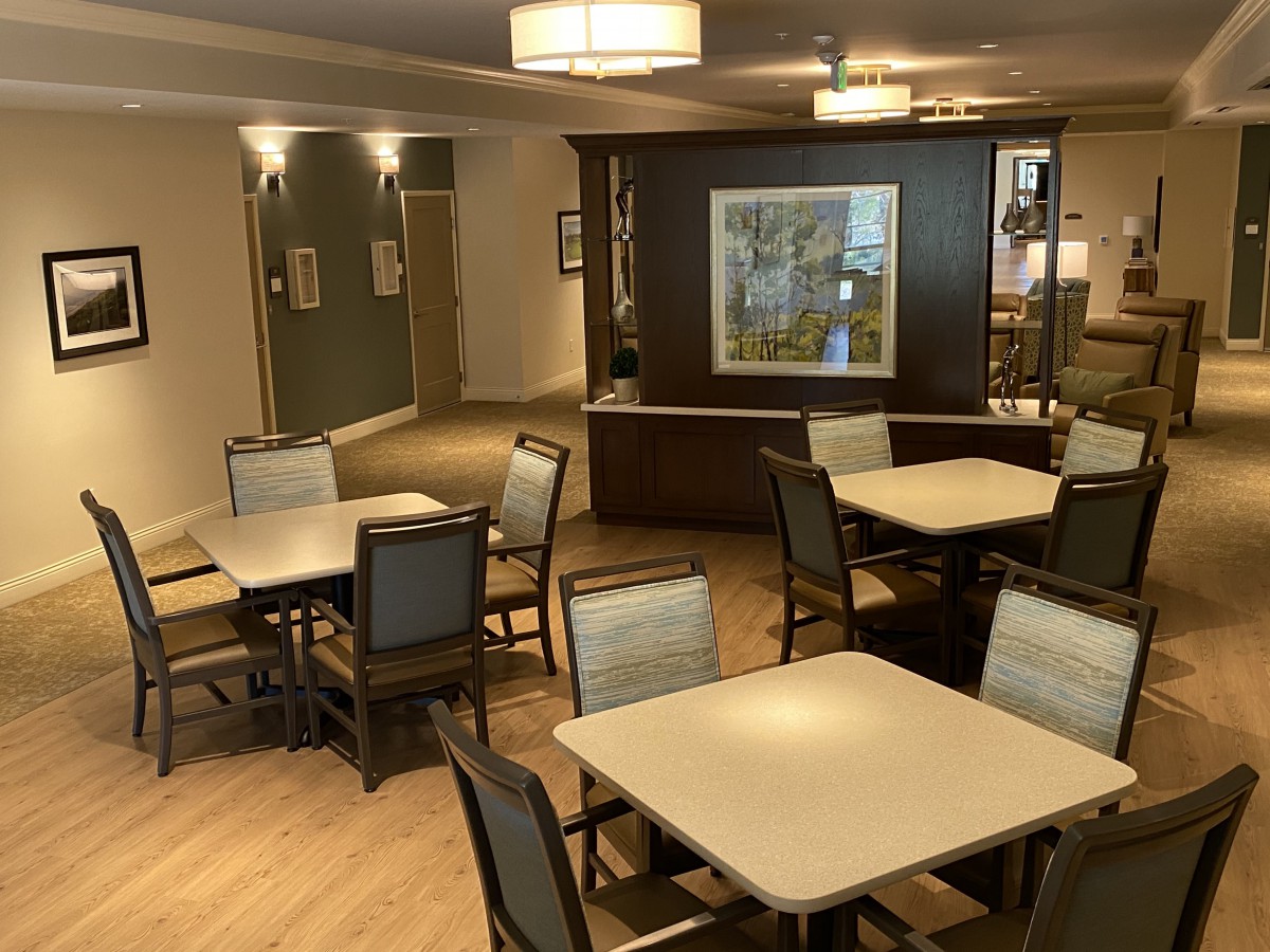 A modern dining area with neatly arranged tables and chairs.