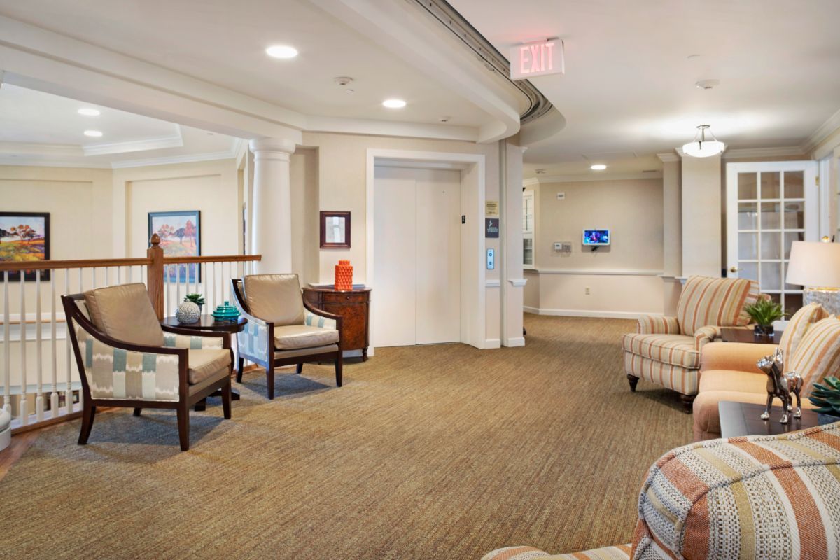 A comfortable lobby area with chairs and an elevator.