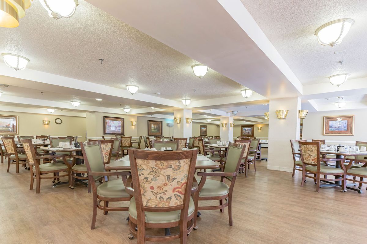 A spacious and well-lit dining area with elegant chairs and tables.
