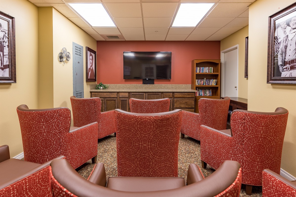 A cozy seating area with a television and bookshelves.