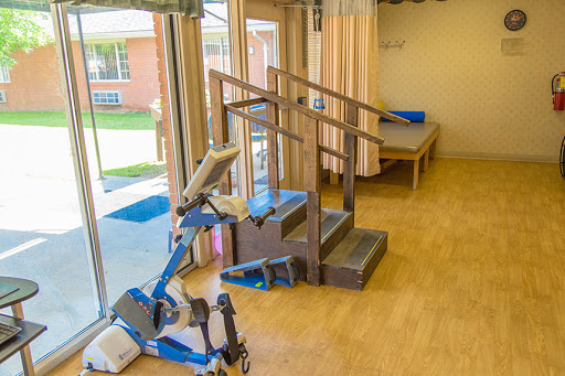A well-equipped rehabilitation room featuring stairs and exercise equipment.