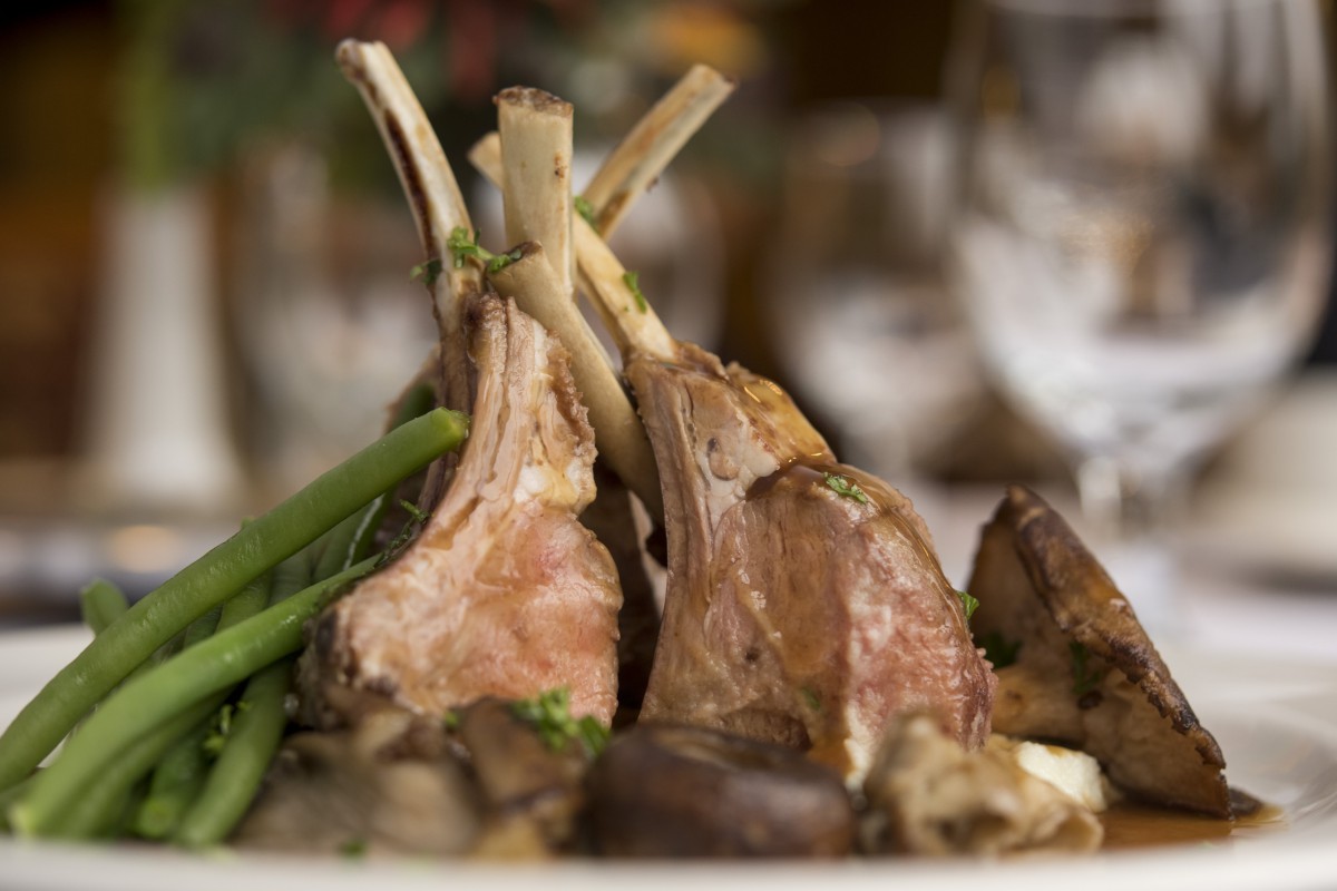 A delicious serving of lamb chops accompanied by vegetables.