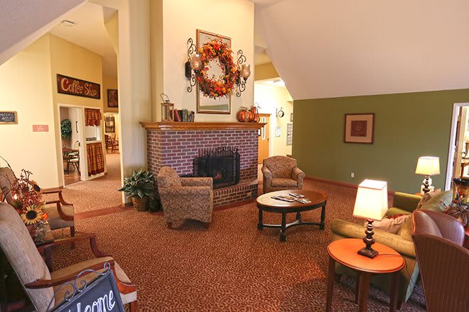 A cozy living room with a brick fireplace and comfortable seating.