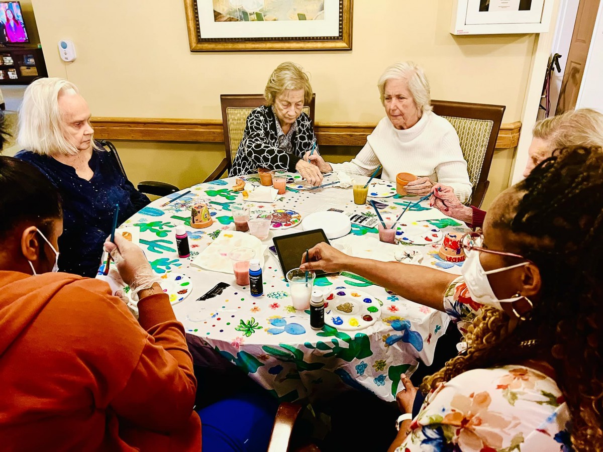 A group of seniors sitting around a table engaged in conversation.
