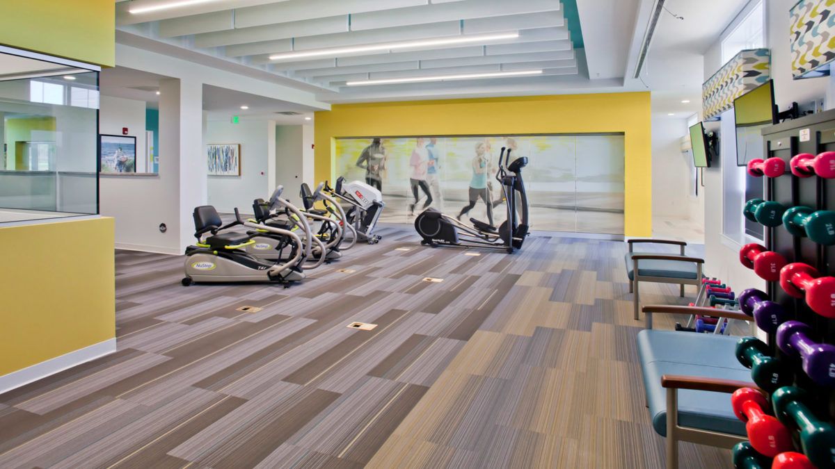 A modern gym equipped with exercise machines and a spacious workout area.