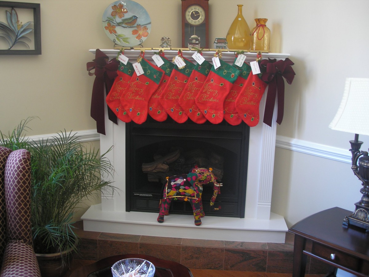 A festive fireplace decorated with red Christmas stockings hanging from the mantel.